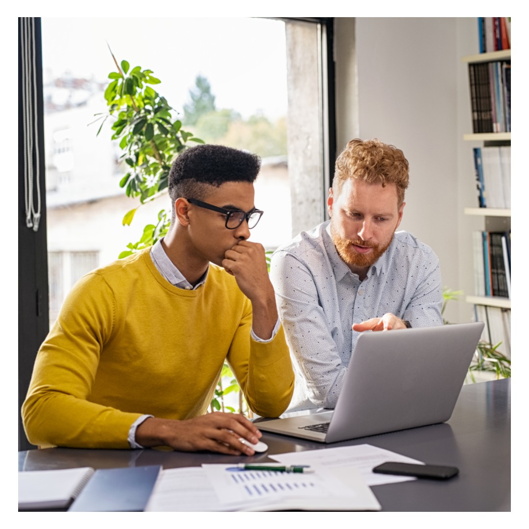 Coworkers working at laptop | Cloud Assessment