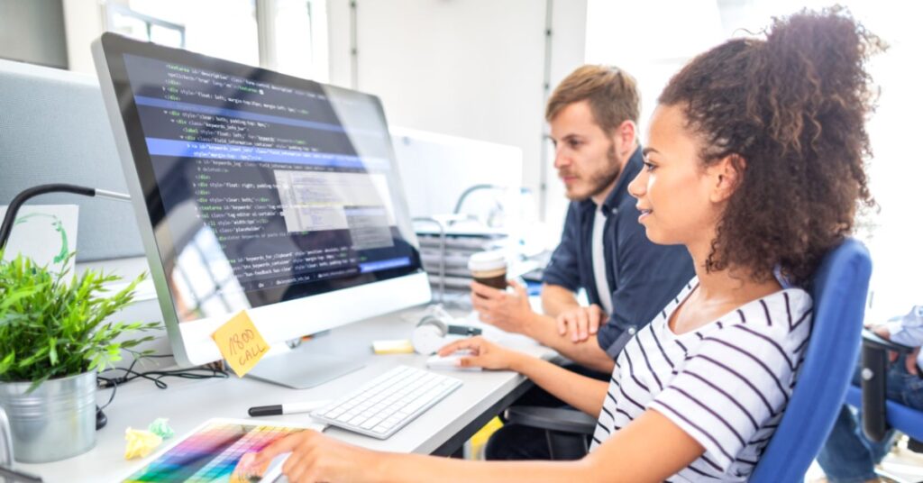 Guy and Lady working At Laptop